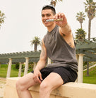 SPS - Natural Inhaler for Mental Stress Soothe Your Mind held by a young man sitting outdoors among palm trees.